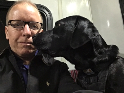 Jake and I on the airport shuttle at LaGuardia airport. My lips are sealed tightly to avoid Jake’s tongue.